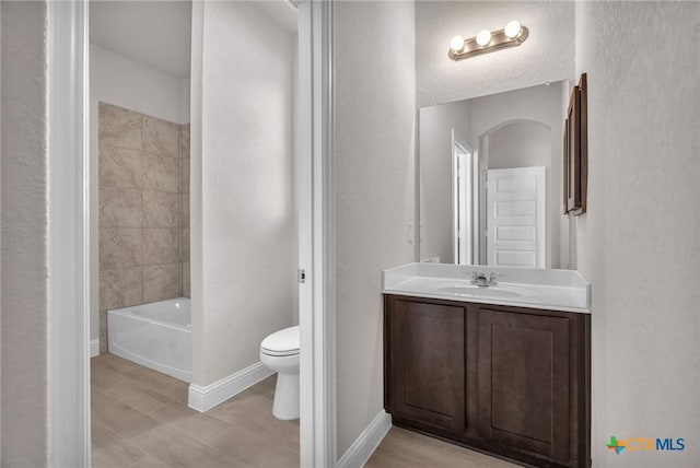 full bathroom with shower / bathing tub combination, vanity, and toilet