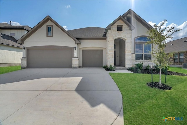 view of front of home with a garage and a front lawn