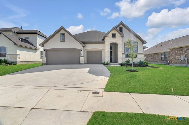 french country home with a front yard and a garage