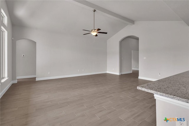 unfurnished living room featuring vaulted ceiling with beams, ceiling fan, and hardwood / wood-style flooring