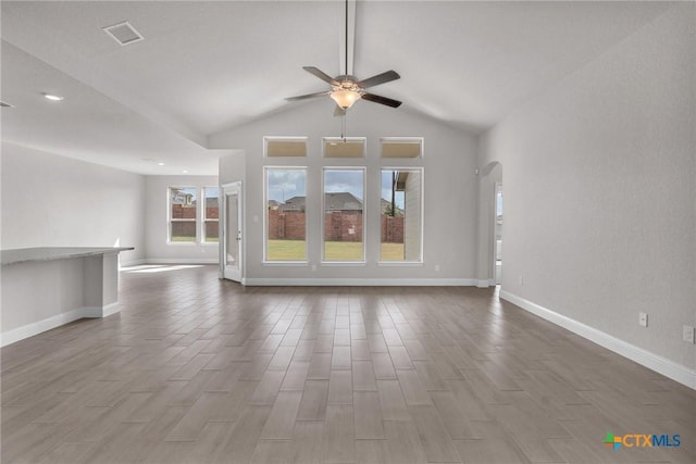 unfurnished living room featuring lofted ceiling, ceiling fan, and wood-type flooring