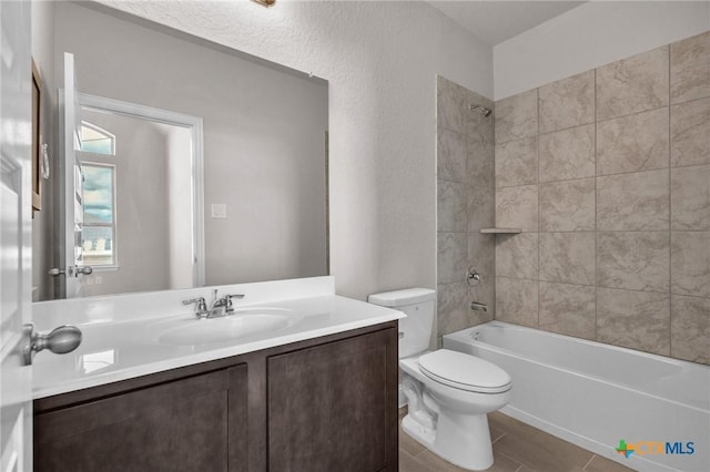 full bathroom with tiled shower / bath combo, toilet, and vanity