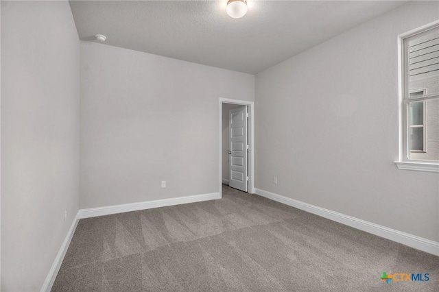 unfurnished room featuring light carpet