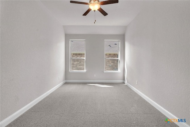 unfurnished room featuring ceiling fan, light colored carpet, and lofted ceiling