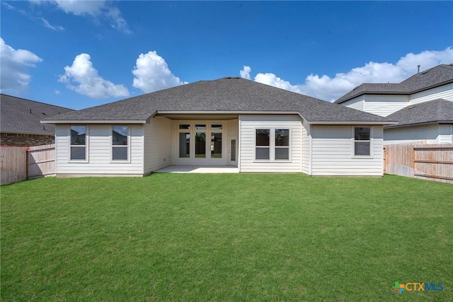 back of house featuring a lawn and a patio area