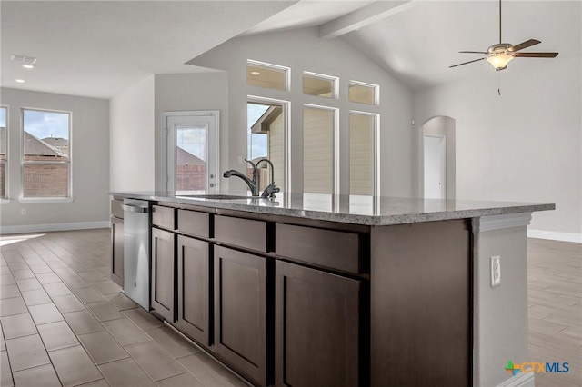 kitchen with dishwasher, sink, vaulted ceiling with beams, an island with sink, and dark brown cabinets