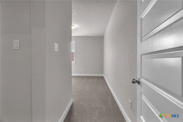 hallway featuring carpet flooring