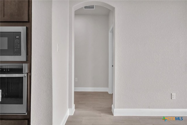 hall with light hardwood / wood-style floors