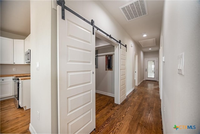 193 Powderhorn Ln, Port Lavaca, TX 77979 - corridor with a barn door, dark wood finished floors, and recessed lighting