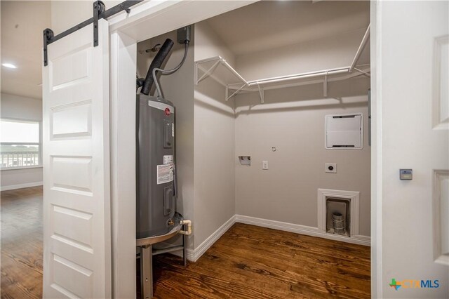 193 Powderhorn Ln, Port Lavaca, TX 77979 - washroom featuring electric dryer hookup, electric water heater, dark wood-style floors, and a barn door