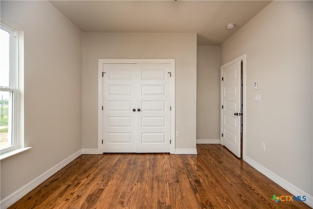 193 Powderhorn Ln, Port Lavaca, TX 77979 - unfurnished bedroom with dark wood-type flooring and a closet