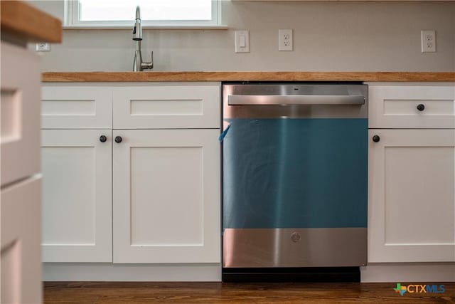 193 Powderhorn Ln, Port Lavaca, TX 77979 - kitchen with stainless steel dishwasher, white cabinets, plenty of natural light, and freestanding refrigerator