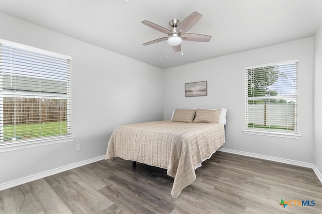 8606 Georgia Ave, Temple, TX 76502 - bedroom with baseboards, ceiling fan, and wood finished floors