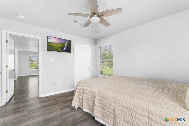 8606 Georgia Ave, Temple, TX 76502 - bedroom with baseboards, visible vents, dark wood-style floors, and multiple windows