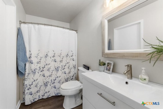 8606 Georgia Ave, Temple, TX 76502 - full bathroom with a shower with shower curtain, toilet, wood finished floors, and vanity