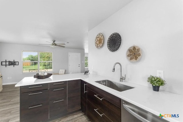 8606 Georgia Ave, Temple, TX 76502 - kitchen featuring dark brown cabinets, a sink, light countertops, dishwasher, and a peninsula