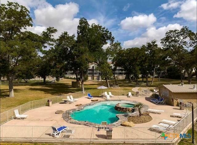 view of pool with a hot tub and a patio