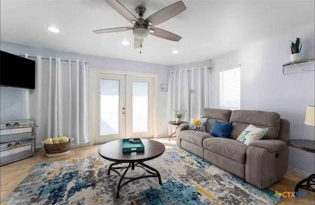 tiled living room with ceiling fan and french doors