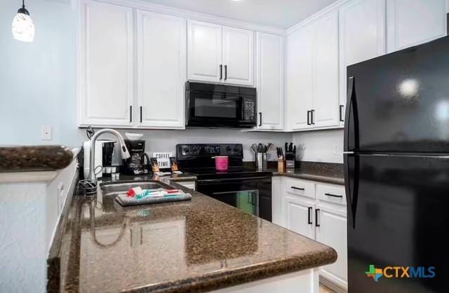 kitchen with pendant lighting, sink, black appliances, white cabinets, and dark stone counters