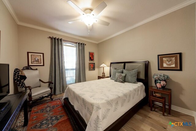 bedroom featuring ceiling fan, wood-type flooring, and crown molding