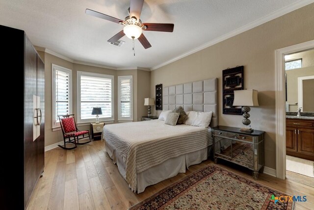 bedroom featuring ensuite bathroom, sink, ceiling fan, light wood-type flooring, and fridge