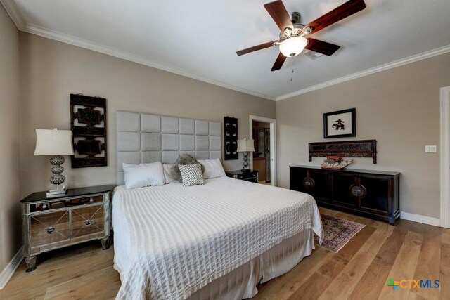 bedroom with ceiling fan, ornamental molding, and light hardwood / wood-style flooring