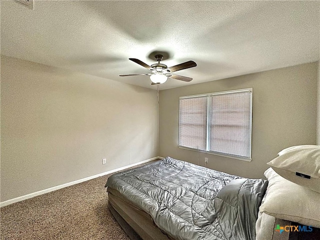 bedroom featuring carpet floors, a textured ceiling, baseboards, and ceiling fan