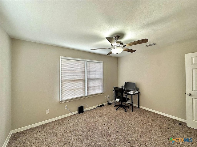 carpeted office with baseboards, a ceiling fan, a textured ceiling, and visible vents