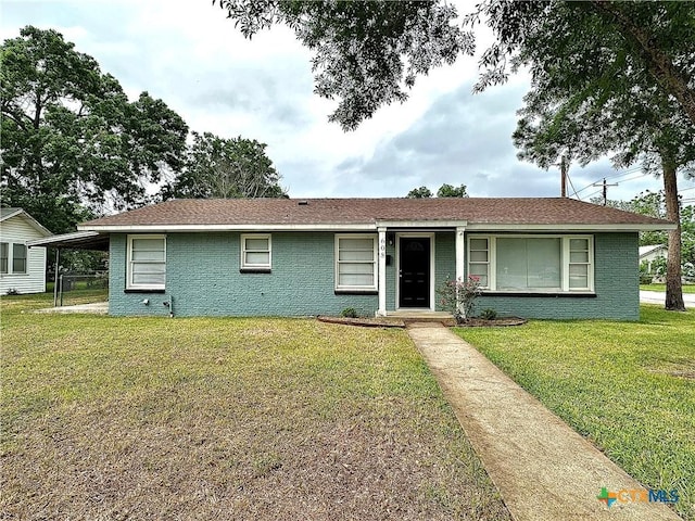 ranch-style house with a front lawn and brick siding