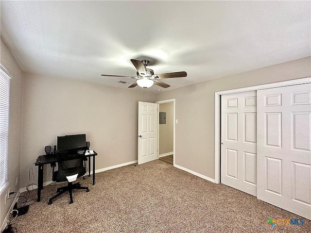 office with baseboards, carpet, ceiling fan, and electric panel