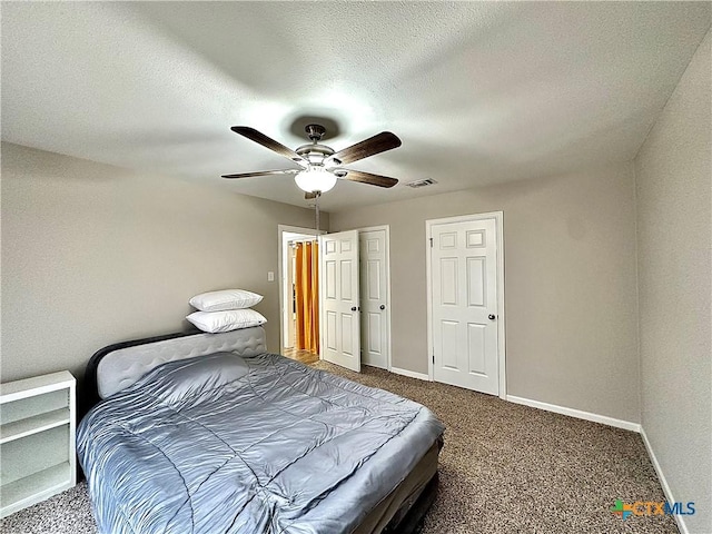 bedroom with carpet floors, baseboards, and visible vents