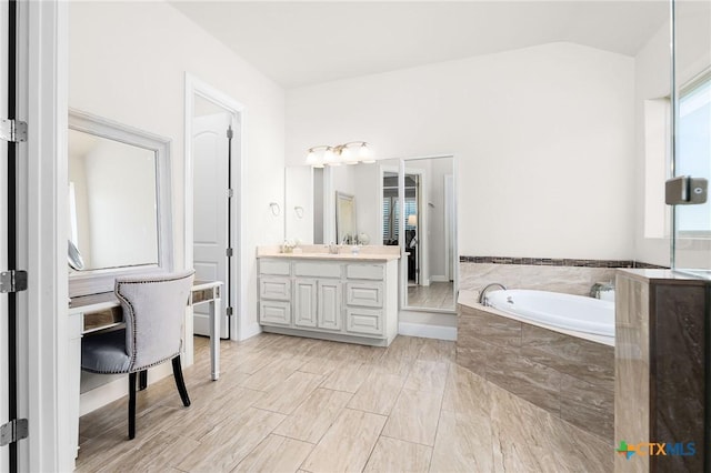 2618 Red Bud Way, New Braunfels, TX 78132 - bathroom with vanity, a garden tub, and vaulted ceiling