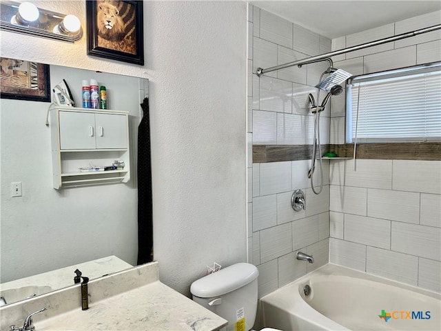 full bathroom with vanity, toilet, and tiled shower / bath