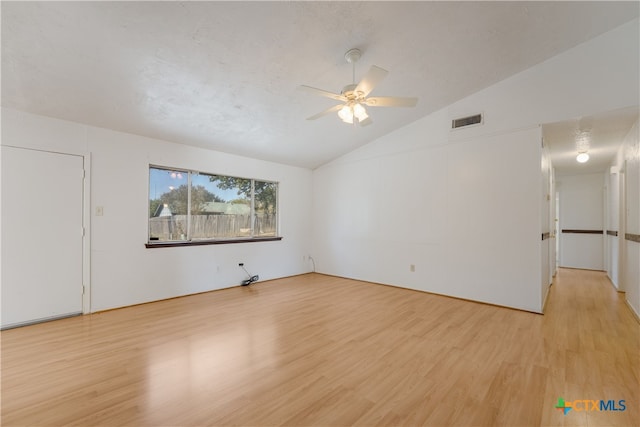 unfurnished room featuring a textured ceiling, ceiling fan, light hardwood / wood-style flooring, and vaulted ceiling