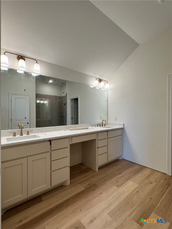 10818 Campsite Cv, Temple, TX 76502 - bathroom with double vanity, a shower stall, wood finished floors, and lofted ceiling