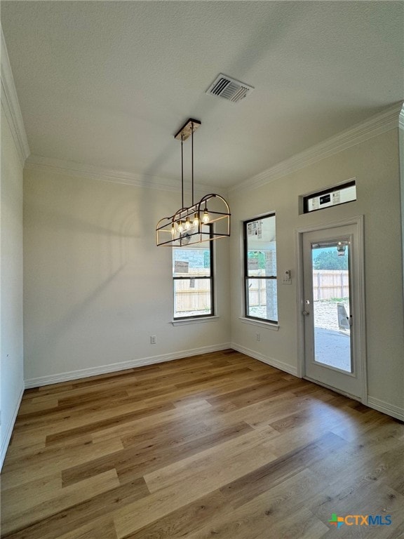 10818 Campsite Cv, Temple, TX 76502 - unfurnished dining area featuring ornamental molding, a chandelier, wood finished floors, baseboards, and a textured ceiling