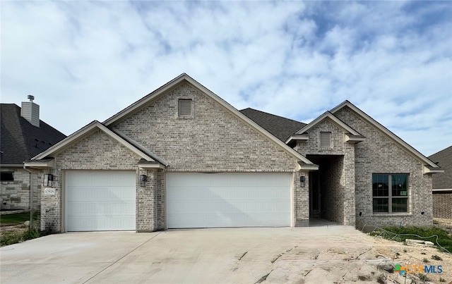 10818 Campsite Cv, Temple, TX 76502 - view of front of home with concrete driveway, a garage, and brick siding