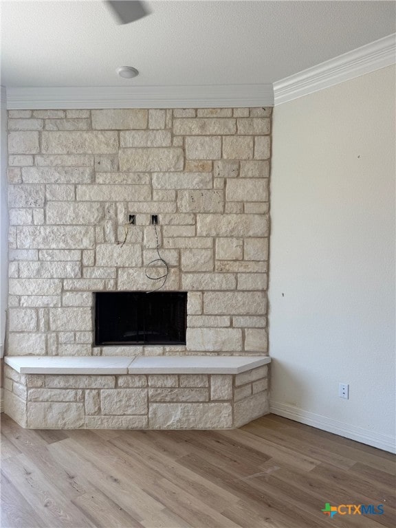 10818 Campsite Cv, Temple, TX 76502 - detailed view of ornamental molding, a fireplace, wood finished floors, and baseboards