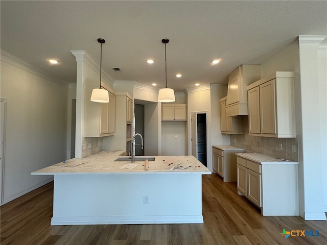 10818 Campsite Cv, Temple, TX 76502 - kitchen with a peninsula, a sink, tasteful backsplash, dark wood finished floors, and crown molding
