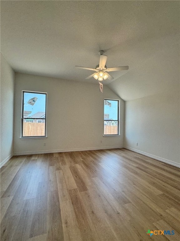 10818 Campsite Cv, Temple, TX 76502 - empty room featuring wood finished floors, a textured ceiling, ceiling fan, baseboards, and lofted ceiling