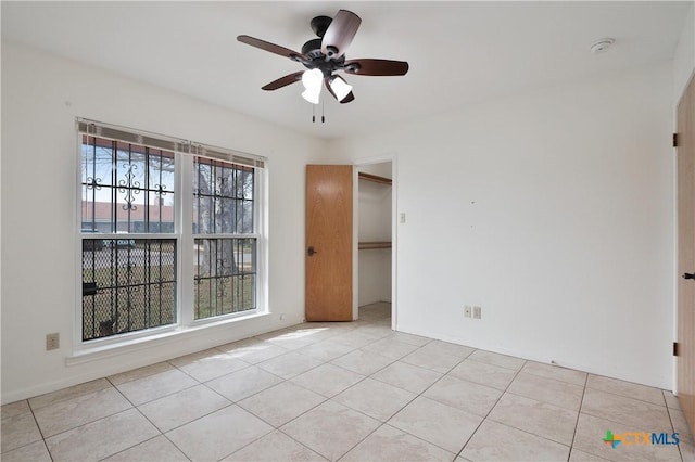 tiled empty room with ceiling fan