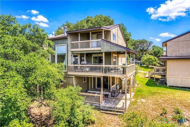 back of property with a patio area, a yard, and a wooden deck