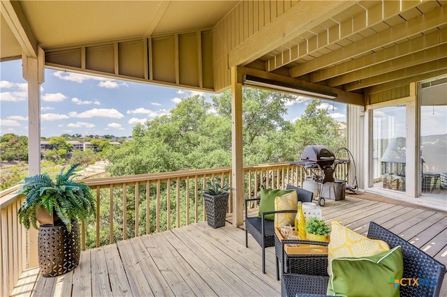 wooden deck featuring a grill