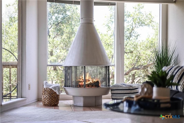 sunroom / solarium with a multi sided fireplace and a wealth of natural light