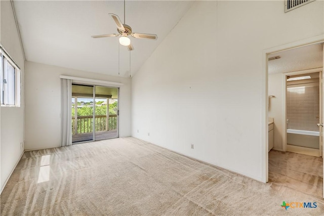 unfurnished room with light carpet, high vaulted ceiling, and ceiling fan