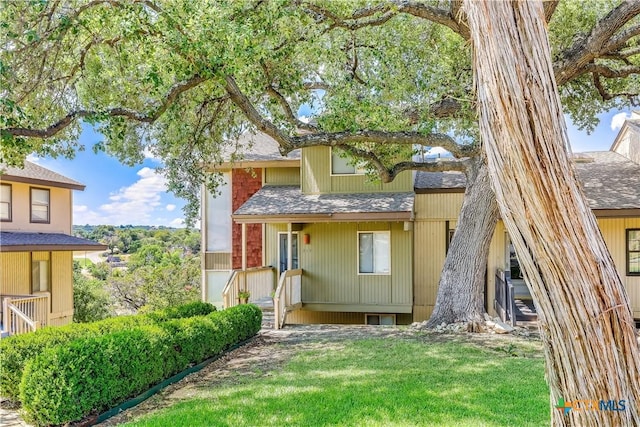 back of property featuring a lawn