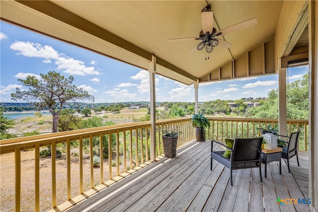 wooden terrace featuring ceiling fan and a water view