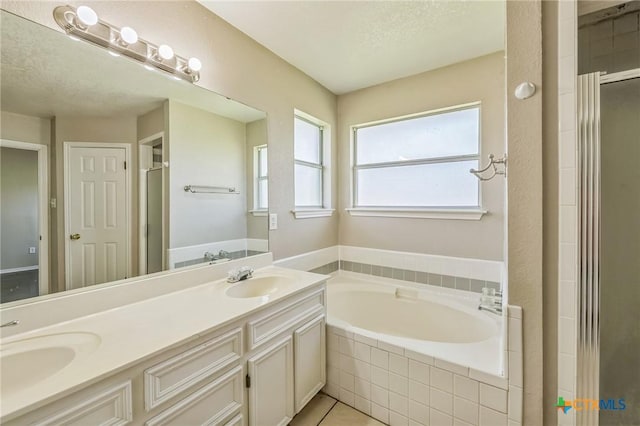 293 Reese Creek Rd, Killeen, TX 76549 - bathroom with double vanity, a bath, a sink, and a stall shower