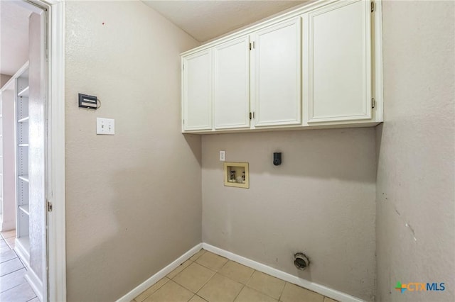 293 Reese Creek Rd, Killeen, TX 76549 - washroom featuring light tile patterned floors, baseboards, hookup for an electric dryer, cabinet space, and hookup for a washing machine