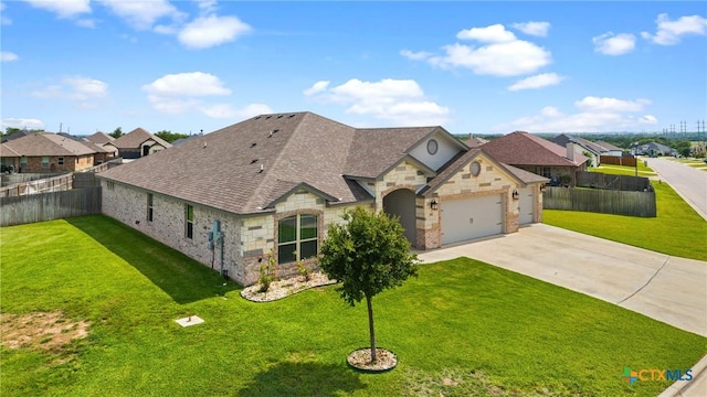 7511 Wind Chime Way, Temple, TX 76502 - french country style house with stone siding, driveway, an attached garage, and a residential view